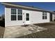 Back exterior featuring large windows, a door and patio at 4889 Lilium Dr, Plainfield, IN 46168