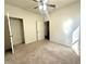 This carpeted bedroom features a ceiling fan and two closets at 4889 Lilium Dr, Plainfield, IN 46168