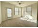 Bedroom featuring neutral carpeting, ceiling fan, and access to outdoor porch at 4889 Lilium Dr, Plainfield, IN 46168