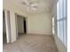 Bedroom featuring neutral carpeting, ceiling fan, and access to an outdoor space at 4889 Lilium Dr, Plainfield, IN 46168