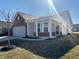 Inviting home exterior featuring a brick accent, covered porch and well-manicured yard at 4889 Lilium Dr, Plainfield, IN 46168