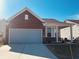 Charming brick and siding home with an attached garage and well-maintained lawn at 4889 Lilium Dr, Plainfield, IN 46168