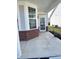Close-up of the front porch with brick accents, white trim, and a glass storm door at 4889 Lilium Dr, Plainfield, IN 46168