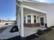 Welcoming front porch with brick accents, white columns, and a storm door entry at 4889 Lilium Dr, Plainfield, IN 46168