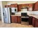 Modern kitchen features stainless steel appliances, gas range, and ample cabinet space at 4889 Lilium Dr, Plainfield, IN 46168