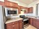 This kitchen has stainless steel appliances, granite countertops, and warm, wood-tone cabinetry at 4889 Lilium Dr, Plainfield, IN 46168