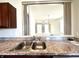 Close up of the kitchen sink and counter area, with a view to a separate room at 4889 Lilium Dr, Plainfield, IN 46168