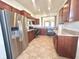 Spacious kitchen with stainless steel appliances and a pass-through window to the living area at 4889 Lilium Dr, Plainfield, IN 46168