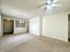 Spacious, carpeted living room features neutral walls, chandelier and ceiling fan at 4889 Lilium Dr, Plainfield, IN 46168