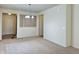 Living room view with carpeted floors, neutral paint, and an entryway with a front door at 4889 Lilium Dr, Plainfield, IN 46168
