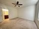 Main bedroom featuring neutral carpeting, ceiling fan, and en-suite bathroom at 4889 Lilium Dr, Plainfield, IN 46168