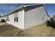 Side exterior view with light-colored siding, windows, and a well-kept lawn at 4889 Lilium Dr, Plainfield, IN 46168