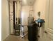 This utility room features a water softener, water heater, and furnace at 4889 Lilium Dr, Plainfield, IN 46168