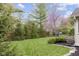 Expansive backyard with mature trees, manicured lawn, and a swing set for endless outdoor fun at 4978 St Charles Pl, Carmel, IN 46033