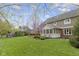 Spacious backyard features a large deck, mature trees, and a swing set for Gathering enjoyment at 4978 St Charles Pl, Carmel, IN 46033