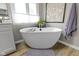 Bright bathroom boasts a soaking tub and a large window that provides plenty of natural light at 4978 St Charles Pl, Carmel, IN 46033