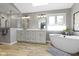 Bathroom with a modern vanity, a glass shower, a soaking tub, and a skylight at 4978 St Charles Pl, Carmel, IN 46033