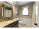 Cozy bathroom with a vanity, framed mirror, and a granite countertop at 4978 St Charles Pl, Carmel, IN 46033