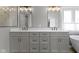 Bathroom with a double vanity and modern mirrors featuring soft gray paint and modern fixtures at 4978 St Charles Pl, Carmel, IN 46033