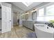 Bathroom featuring a freestanding tub, shower, and double vanity with modern fixtures and finishes at 4978 St Charles Pl, Carmel, IN 46033