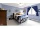 Blue bedroom with a sports theme, a closet, and a window with dark curtains at 4978 St Charles Pl, Carmel, IN 46033