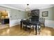 Charming dining room featuring hardwood floors, a modern chandelier and a dark wood china cabinet at 4978 St Charles Pl, Carmel, IN 46033