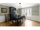 Lovely dining room features hardwood floors, a modern chandelier, bay windows and a dark wood china cabinet at 4978 St Charles Pl, Carmel, IN 46033