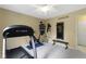 Bright exercise room featuring a treadmill and mounted equipment storage at 4978 St Charles Pl, Carmel, IN 46033