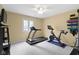 Bright exercise room featuring a treadmill, a fan, and a Peleton bike at 4978 St Charles Pl, Carmel, IN 46033