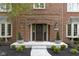 Close-up of a brick home's entrance with a decorative front door, sidelights, and landscaping at 4978 St Charles Pl, Carmel, IN 46033