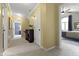 Hallway features neutral carpeting, sunny yellow walls, and white trim, with an open doorway to a bedroom at 4978 St Charles Pl, Carmel, IN 46033