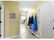 Inviting hallway with tile flooring and coat hooks for added convenience near the laundry room at 4978 St Charles Pl, Carmel, IN 46033