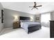 Spacious bedroom features a large bed, ceiling fan, and a window with natural light at 4978 St Charles Pl, Carmel, IN 46033