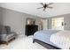 Bedroom with neutral carpeting and gray walls features a dark wood dresser and an accent chair at 4978 St Charles Pl, Carmel, IN 46033