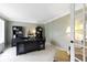 This bright home office features a large desk, built-in cabinets, and plush carpet, making it ideal for working at 4978 St Charles Pl, Carmel, IN 46033