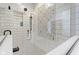 Shower with tiled walls, built in shelving, modern shower head, and decorative tile accents at 4978 St Charles Pl, Carmel, IN 46033