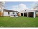 Landscaped backyard with a fire pit area, lush green grass, a detached garage and string lights at 536 W 52Nd St, Indianapolis, IN 46208