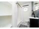 Cozy bathroom with a shower, a circular window, and a dark-colored vanity at 536 W 52Nd St, Indianapolis, IN 46208