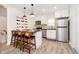 Well-lit kitchen with white cabinetry, stainless steel appliances, and counter seating at 536 W 52Nd St, Indianapolis, IN 46208