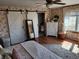 Charming bedroom featuring barn doors, stylish furniture, and a patterned rug at 551 E 600 S, Lebanon, IN 46052