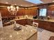 Traditional-style kitchen with custom wood cabinets and a granite-topped island, exuding warmth at 551 E 600 S, Lebanon, IN 46052