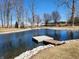 Scenic pond with a double wooden dock, surrounded by trees and lush green grass at 551 E 600 S, Lebanon, IN 46052