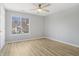 Bright bedroom with a ceiling fan and large window that lets in natural light at 6525 Emerald Hill Ct # 207, Indianapolis, IN 46237
