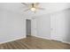 Cozy bedroom with a ceiling fan, two windows, and hardwood floors at 6525 Emerald Hill Ct # 207, Indianapolis, IN 46237