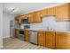 Well-lit kitchen features stainless steel appliances, light countertops, and light wood cabinets at 6525 Emerald Hill Ct # 207, Indianapolis, IN 46237