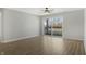 Bright living room with a ceiling fan, a sliding glass door, and wood-look floors at 6525 Emerald Hill Ct # 207, Indianapolis, IN 46237