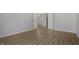 Open living room with hardwood floors, neutral paint, and white trim at 6525 Emerald Hill Ct # 207, Indianapolis, IN 46237