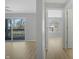 Bright living room showing an open floor plan, wood-look flooring, and access to a balcony at 6525 Emerald Hill Ct # 207, Indianapolis, IN 46237