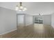 Open living room featuring hardwood floors, neutral walls, and a sliding door to the outside at 6525 Emerald Hill Ct # 207, Indianapolis, IN 46237