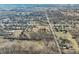 High aerial view of neighborhood with houses, trees, a road and a rural setting in the distance at 6603 Iona Rd, Indianapolis, IN 46203